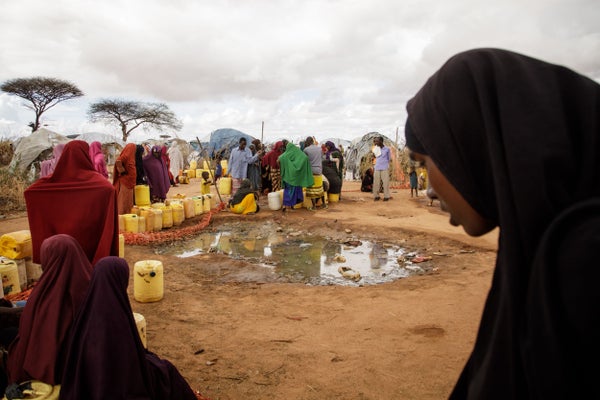 People gathered during drought to receive water at distribution center