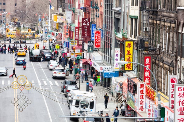 A city street with predominantly Chinese-language signs.