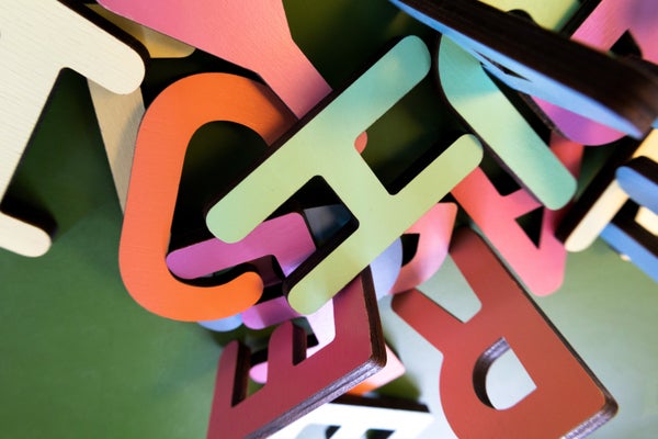 Scramble of variously colored wooden alphabet letters