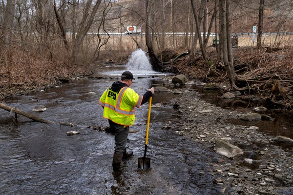 An EPA employee checks creek for chemicals