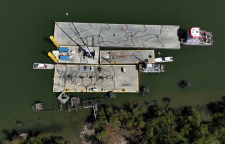 In an aerial view, barges filled with fresh water transfer the water the Port Sulphur Water Plant