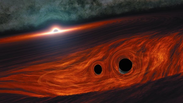 Two small black holes coalescing within a disk of gas and dust around a supermassive black hole