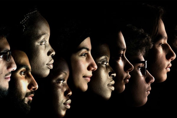 Profiles of faces of people of various ethnicities on black background in row.
