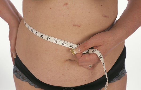 woman holding belly fat
