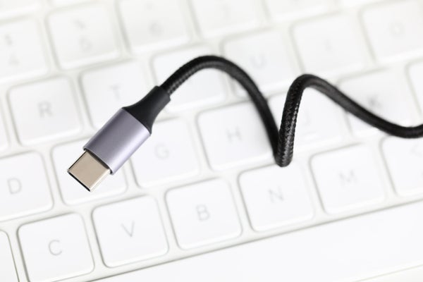 Close-up of a USB-C charging cable over a keyboard.