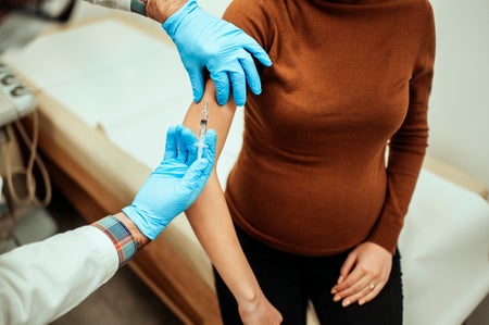 A pregnant woman getting vaccinated.