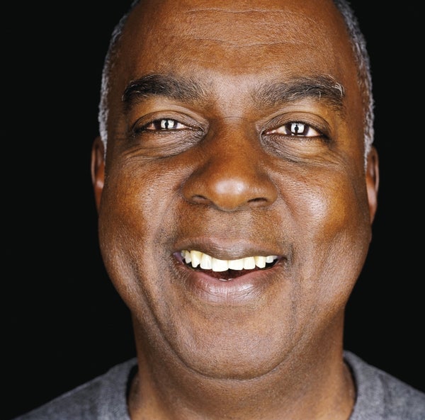 Middle age black man smiling at the camera.
