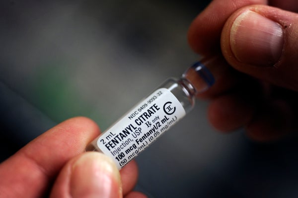 A hand holds a vial marked "Fentanyl Citrate."