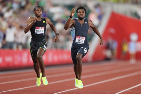 Two runners sprint on a track.