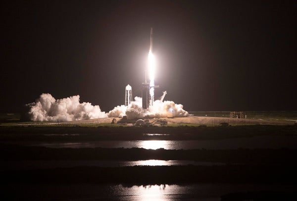 Rocket taking off at night.