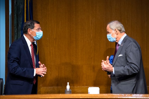 Sen. John Barrasso, R-Wyo., left, talks with Sen. Tom Carper