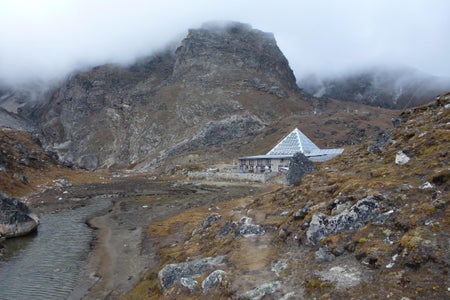 A laboratory with a pyramid-shaped roof nestled into a hillside