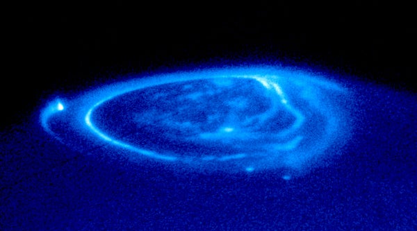 An image of a dazzling aurora around Jupiter's north pole.