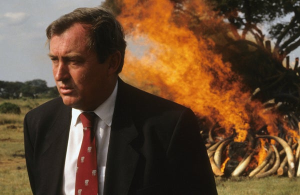 Richard Leakey in front of a burning heap of elephant tusks.