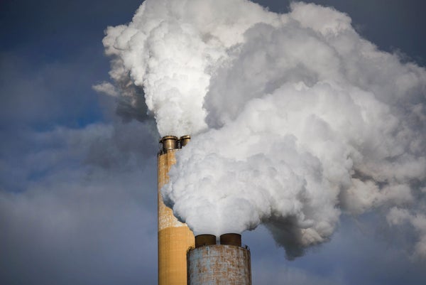 Emissions billowing from smoke stacks