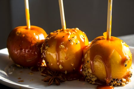 Festive caramel apples on sticks.