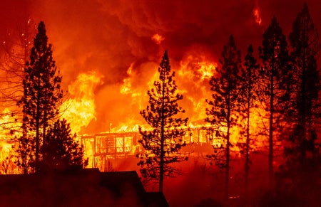 home engulfed in flames during the Creek Fire