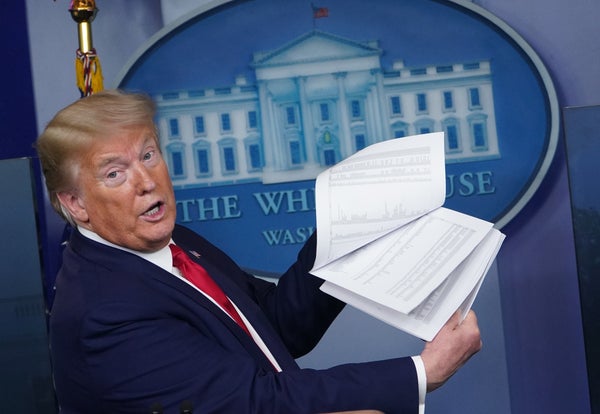 US President Donald Trump holds up papers displaying federal locations for testing during the daily briefing on the novel coronavirus, COVID-19, in the Brady Briefing Room of the White House in Washington, DC on April 20, 2020.