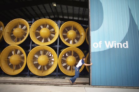 A person slides open doors revealing giant fans