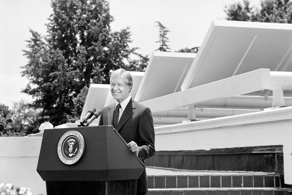 President Jimmy Carter speaking in front of solar panels at White House