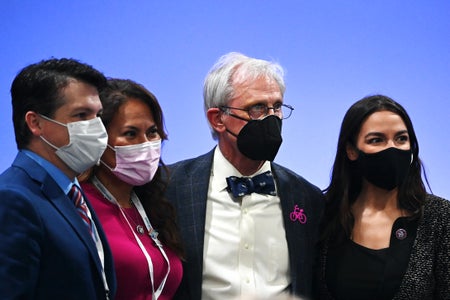 US Democratic Democratic Representatives Veronica Escobar (2L) and Alexandria Ocasio-Cortez (R) pose for a photograph with attendees ahead of a speech by US Speaker of the House Nancy Pelosi on November 9, 2021 in Glasgow, Scotland.