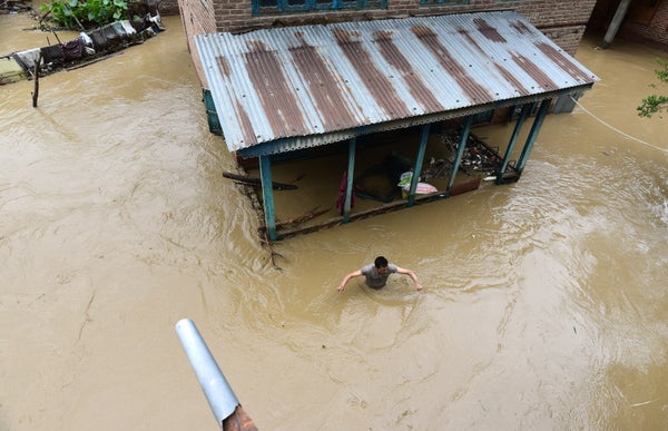 Aerial view of person wading through heavy flood waters