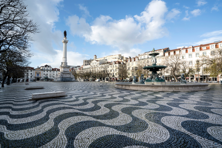 Dark and bright waves adorn the pavement of Rossio Square in Lisbon, Portugal.