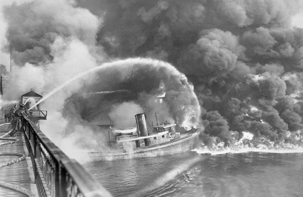 Black and white photo of burning tugboat