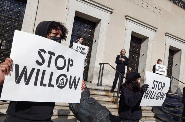 Climate activists hold demonstration posters stating STOP WILLOW