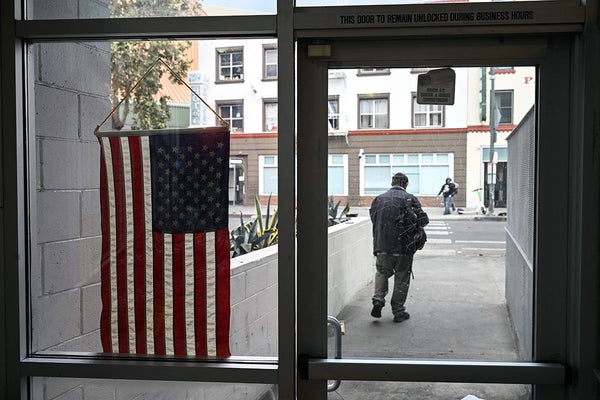 A US flag hangs in the window of a voting center
