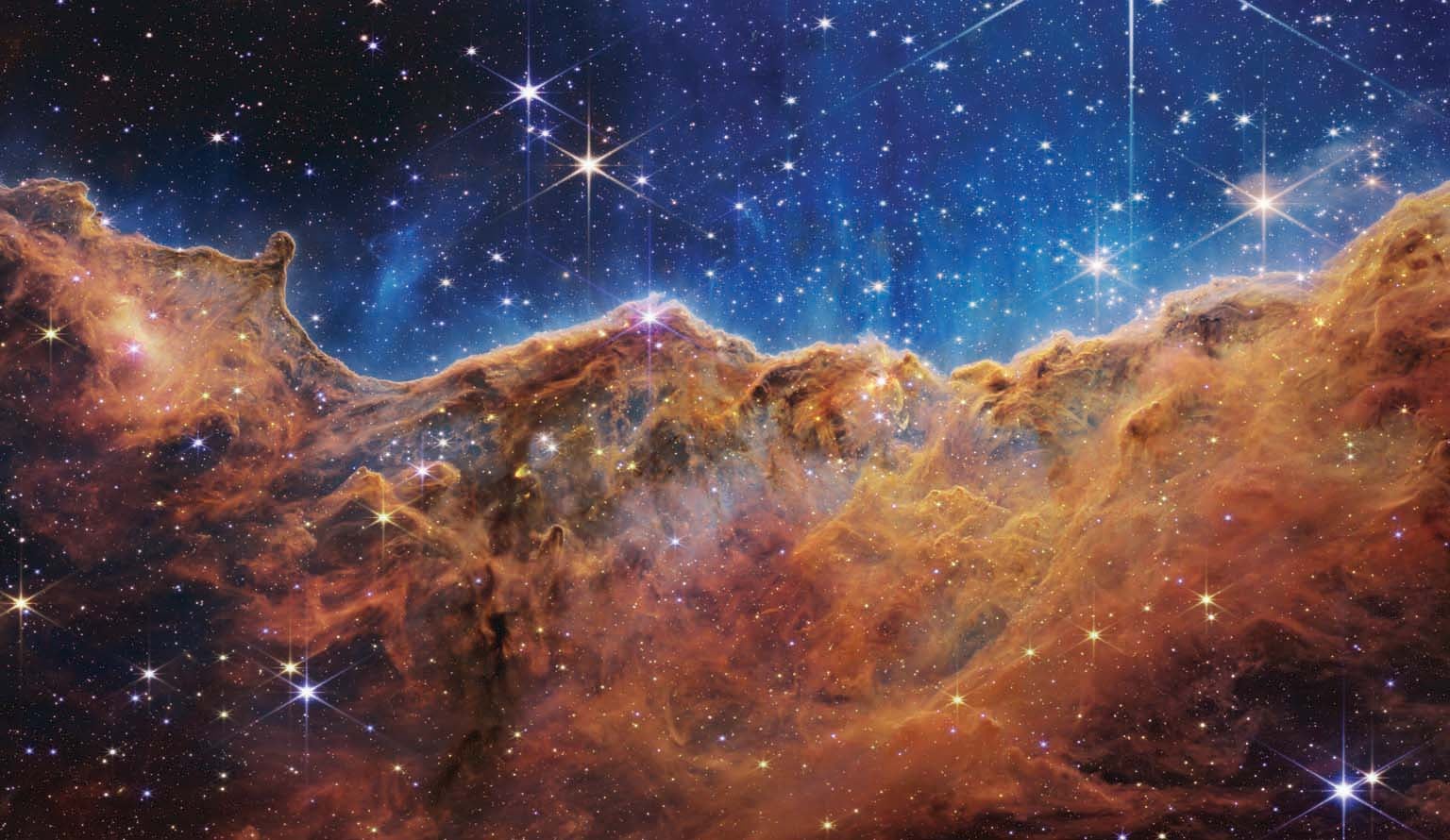 Newborn stars in the stellar nursery known as the Carina Nebula, a vast agglomeration of gas and dust.