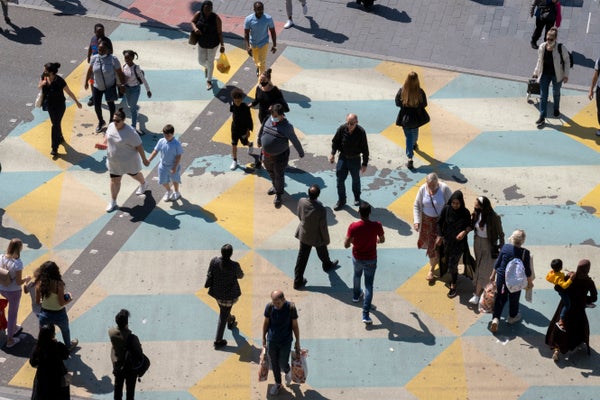 Aerial view of pedestrians in city crosswalk.