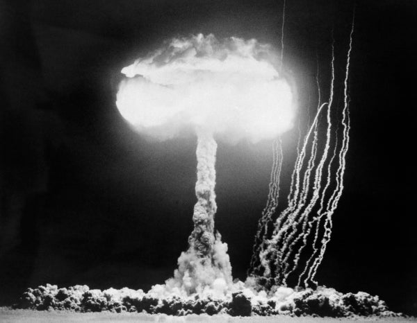 Black-and-white historical photo of mushroom cloud from nuclear blast.