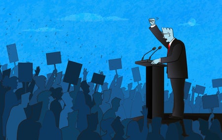 Politician speaking to a large crowd of people.