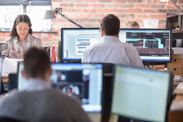 office, workplace, people sitting at desks, working on computers