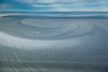 Aerial of circular Arctic sea ice patterns.