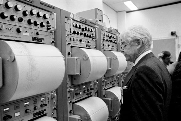 Dr. Maurice Ewing studies seismometer readings.