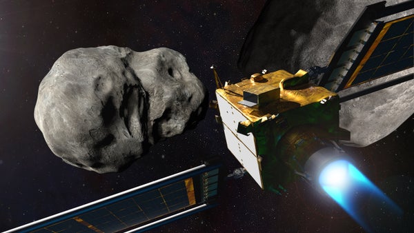 A space probe with extended solar panels approaches a huge, irregular rock in outer space.