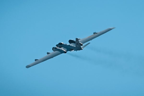 A WB-57 aircraft in flight in blue skies