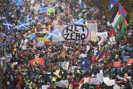 Massive crowd of activists in street with signs.