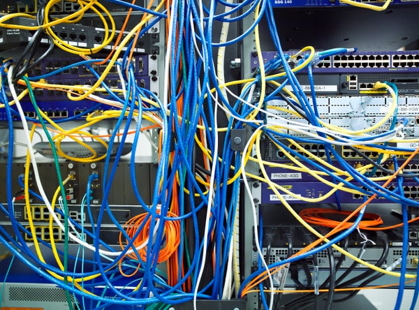 A tangled mass of colored wires on a server.