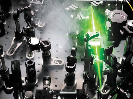 Optical setup points a green light beam toward a metamaterial.