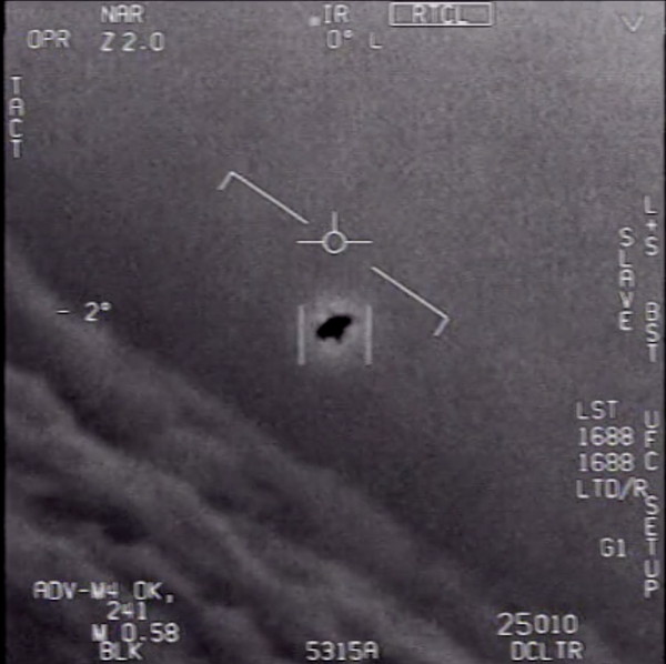 An unknown flying object is seen in a grainy video still.