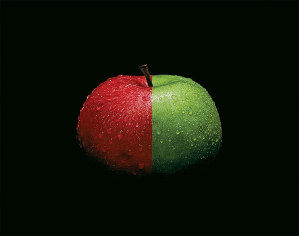 An apple half red and half green.