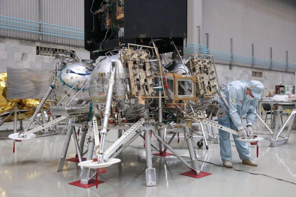 A man is seen working on the Luna-25 lander.