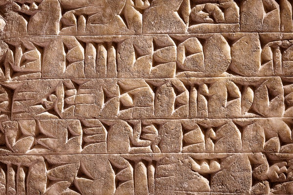 A closeup of ancient cuneiform script carved into clay or stone