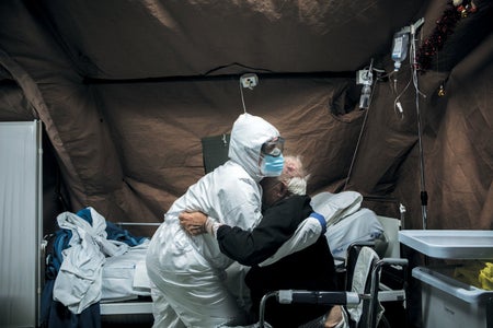 Italian army nurse helps a COVID patient at a camp hospital in Perugia.