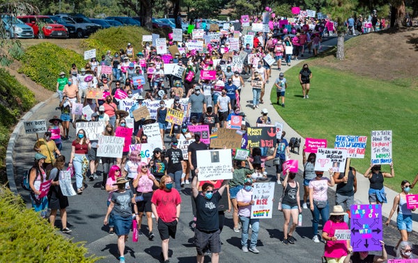 Hundreds carrying signs leave the North Justice Center in Fullerton for a women"u2019s reproductive rights march in Fullerton on Sat. Oct.2 2021