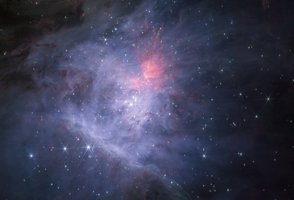 Clouds of Cosmic Dust Glow Near the Orion Nebula