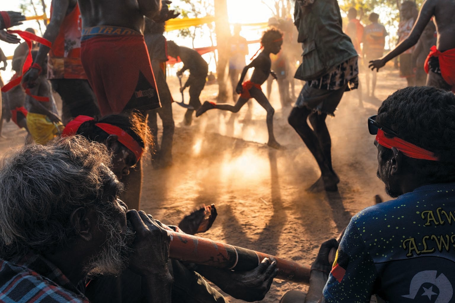 Energetic scene of people dancing in traditional clothing.